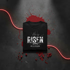 He Is Risen organic oversized tee in black folded — empty tomb and rolled stone print, Matthew 28:6, KingJesus.shop