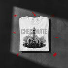 Checkmate oversized tee in white folded — black chess king over fallen pieces, Colossians 2:15, KingJesus.shop