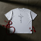 By His Wounds oversized tee in white flat lay — ink-wash hand print, by His wounds we are healed