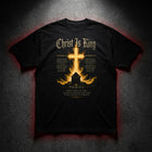 Christ Is King Premium Heavyweight Tee — flat lay DTG print on dark concrete
